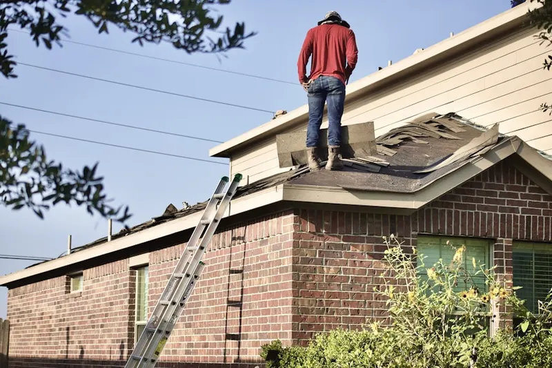 Professional roofer working on a residential roof in Wilkes
